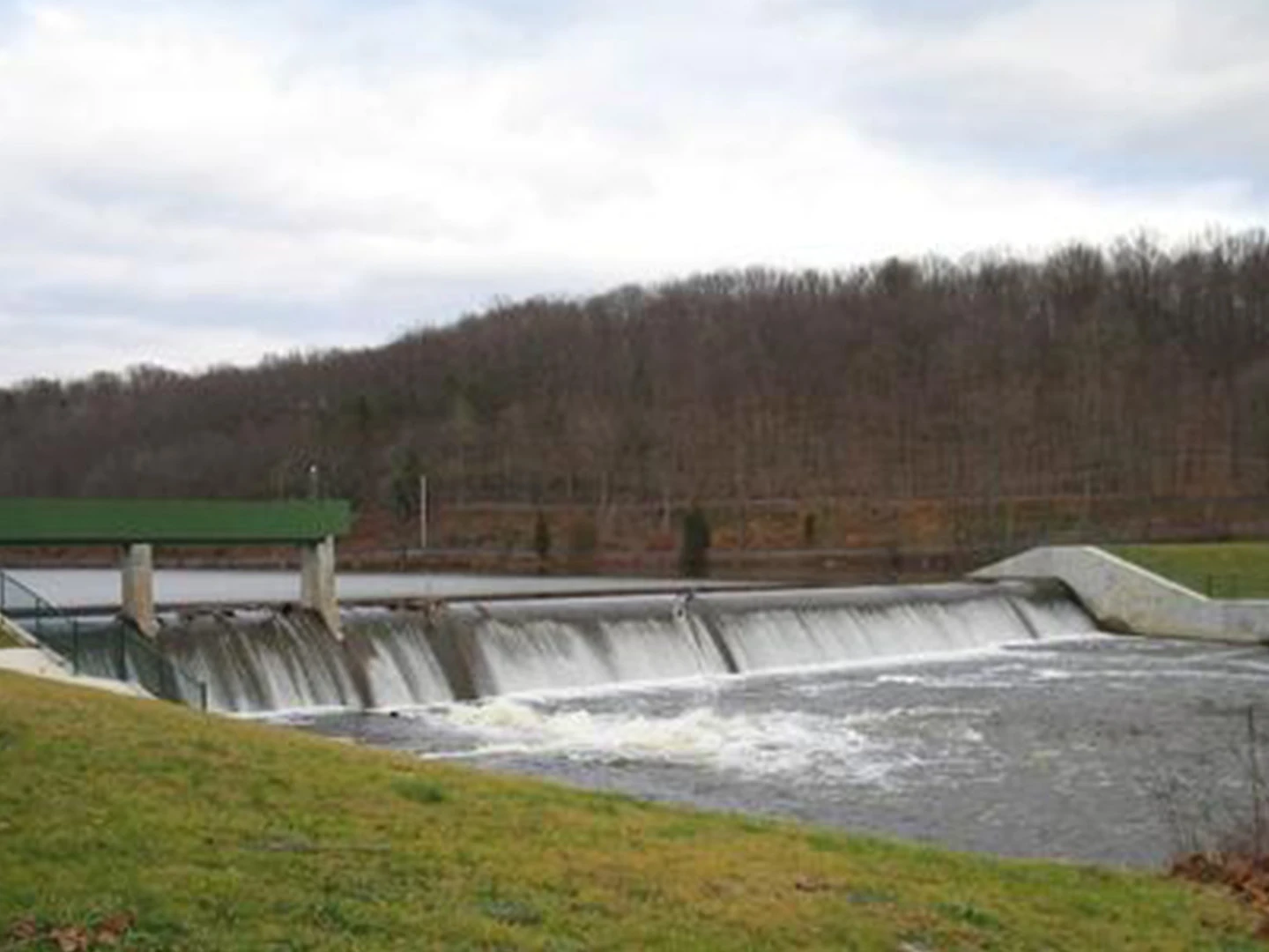 A large body of water with several dams and a green roof.