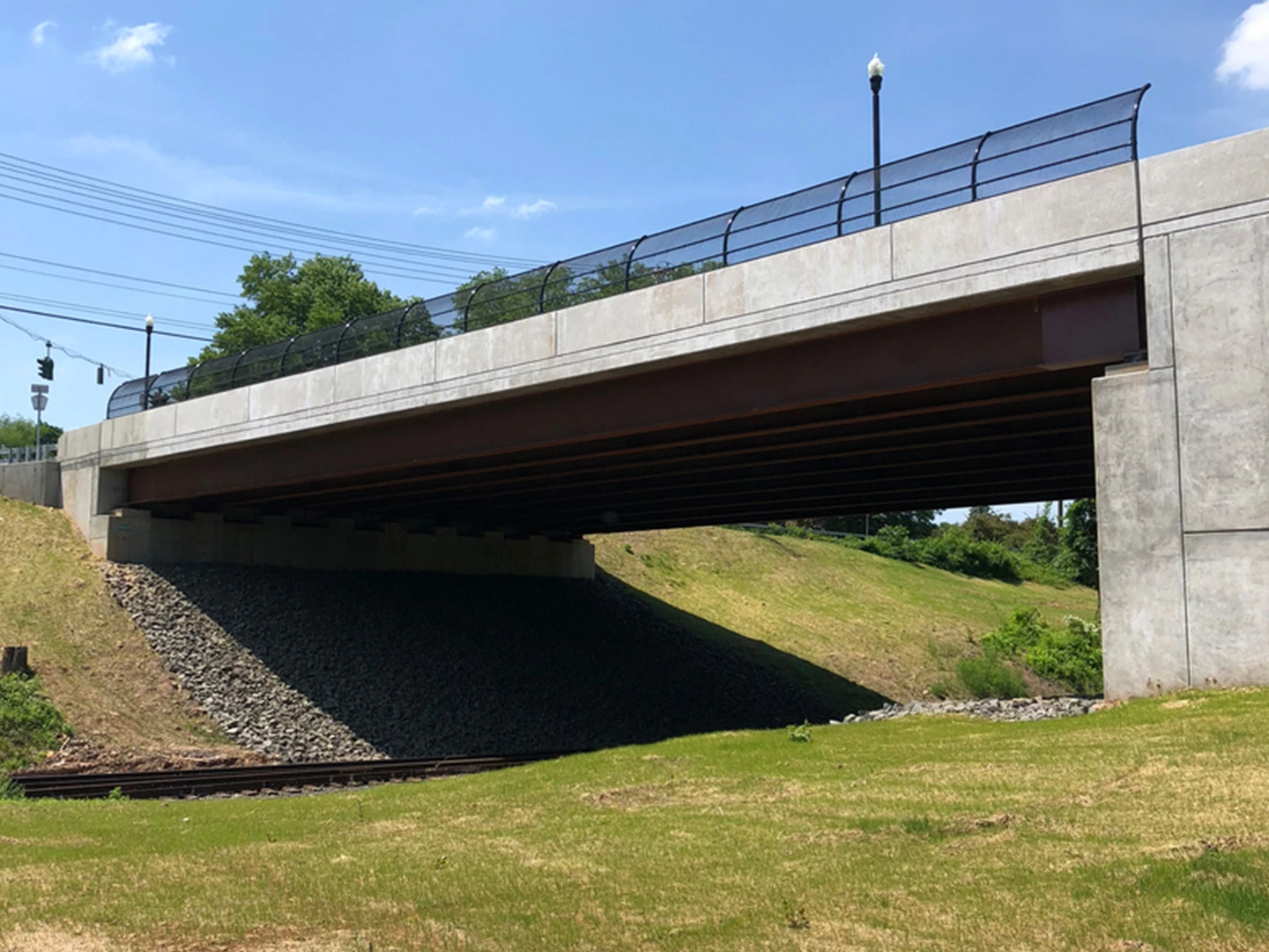 A bridge with grass and trees in the background