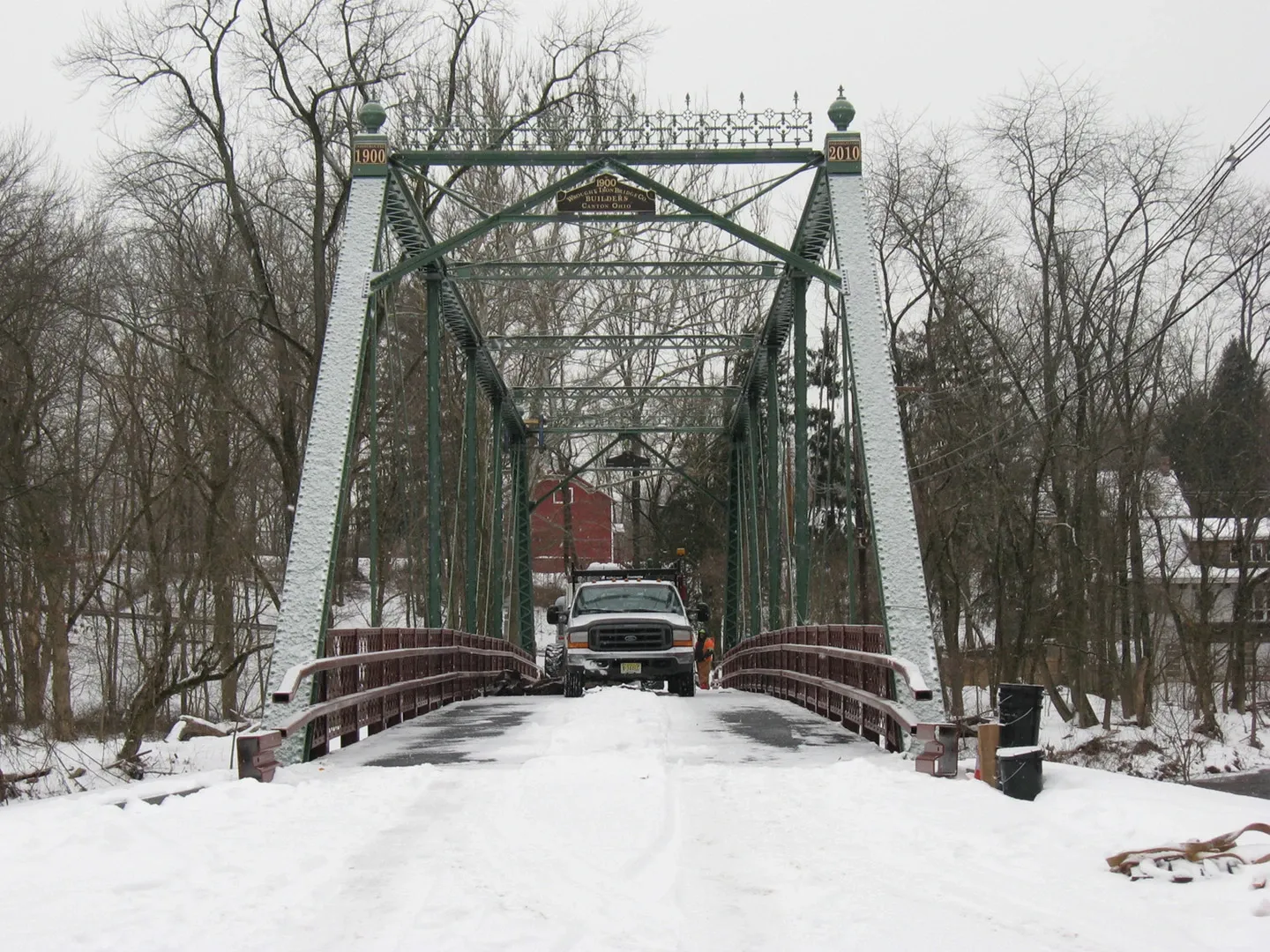 A car is crossing over the bridge in winter.