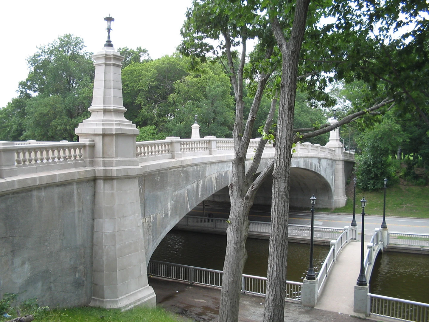 A bridge with trees and water in the background