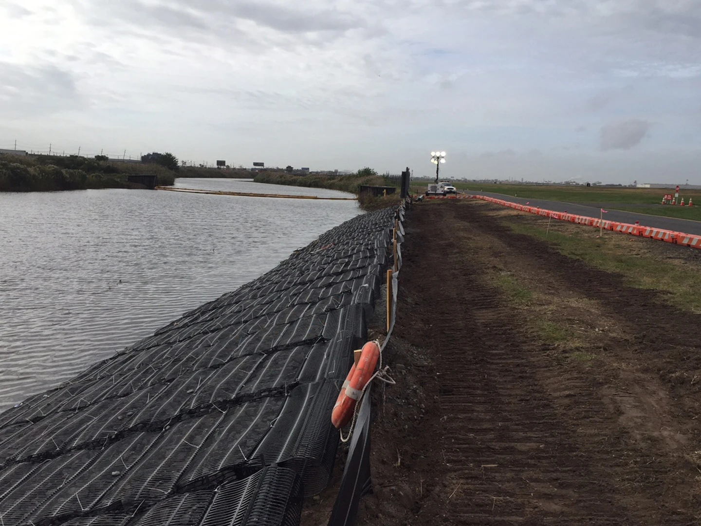 A fence that is next to the water.